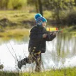 Children in winter clothes playing with water guns